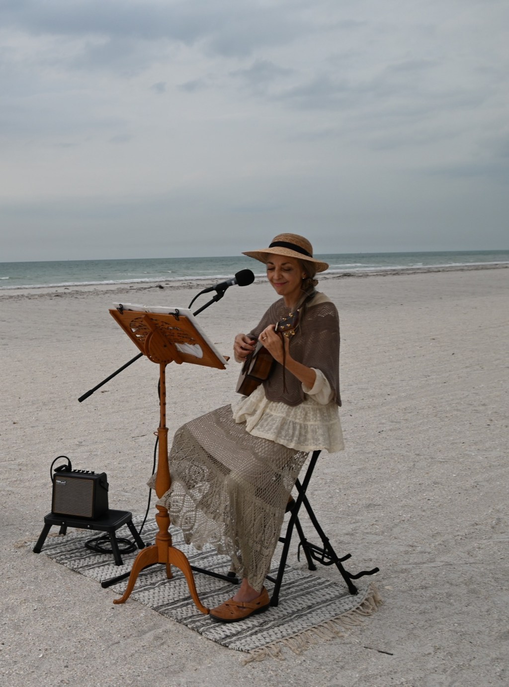 connie manson playing ukulele on the beach